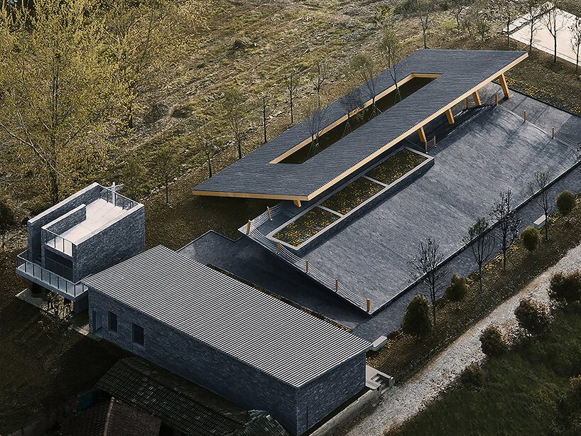 topped with a slanted canopy, this pavilion doubles as a viewing platform in rural china