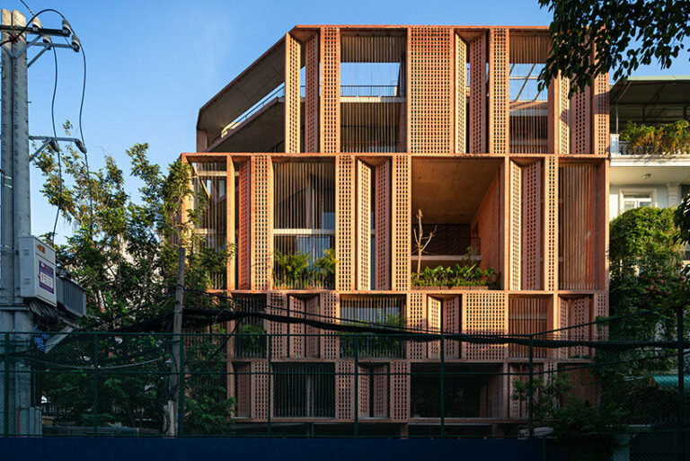 tropical space encloses 'premier office' with a porous brick facade