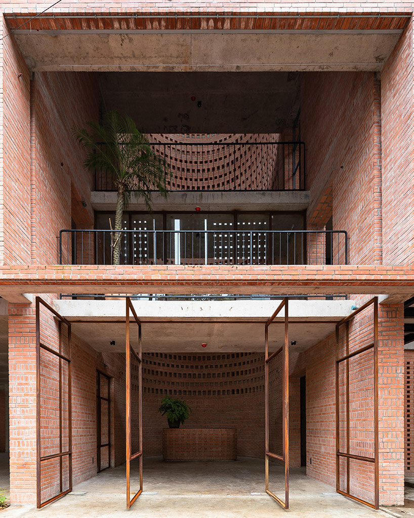 tropical space encloses 'premier office' with a porous brick facade