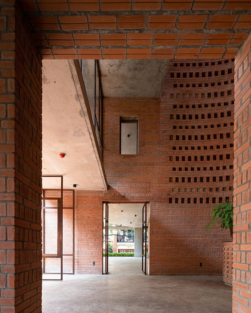 tropical space encloses 'premier office' with a porous brick facade