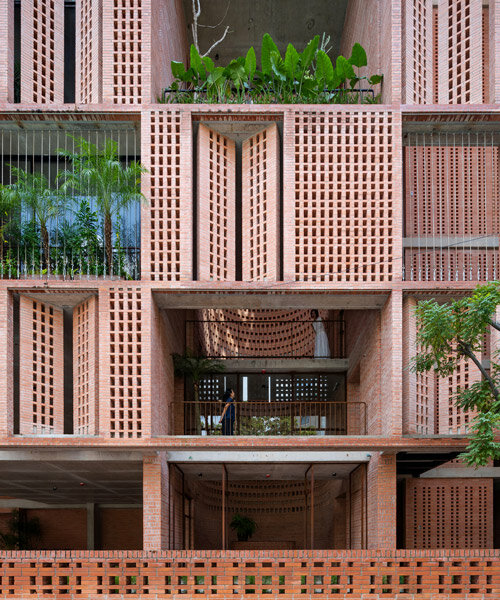tropical space encloses this 'premier office' with a facade of porous brick shutters