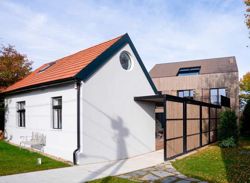 inlaid wooden board structure extends old 50s cottage in austria