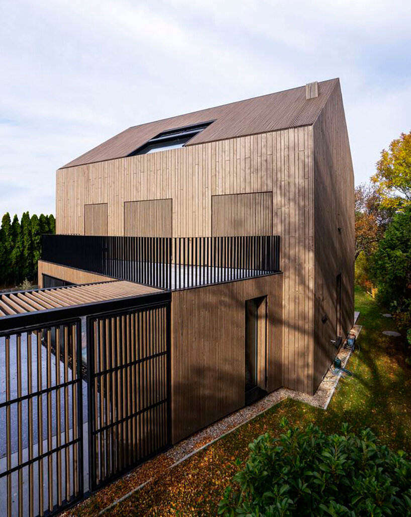inlaid wooden board structure extends old 50s cottage in austria