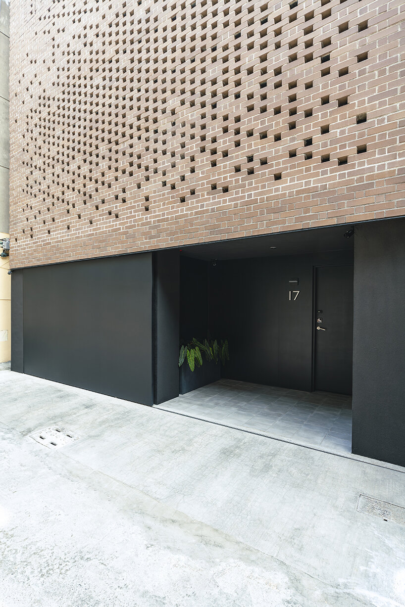 a tapestry-like facade made of clay bricks weaves across paperfarm's veil house in taiwan