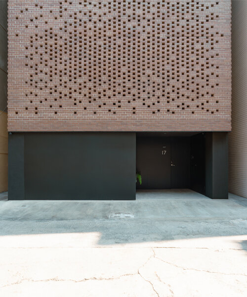 a tapestry-like facade made of clay bricks weaves across paperfarm's veil house in taiwan