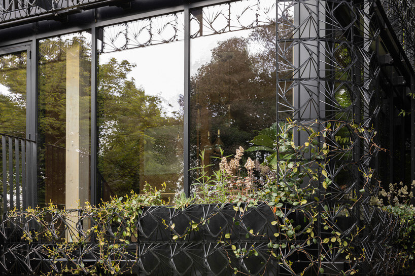 an intricate facade of 'woven' steel promotes a picturesque climbing garden in england