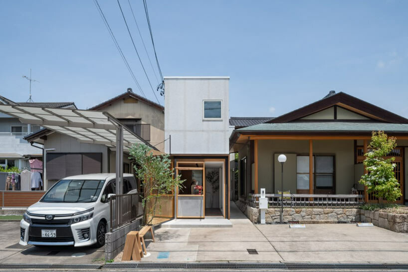 maki yoshimura wedges tiny box-like bakery shop between two houses in japan