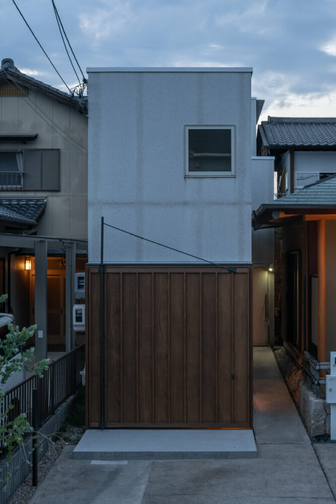 maki yoshimura wedges tiny box-like bakery shop between two houses in japan