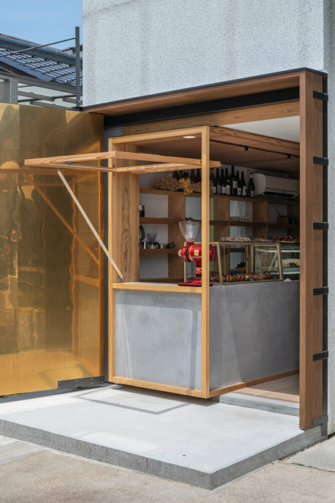 maki yoshimura wedges tiny box-like bakery shop between two houses in japan