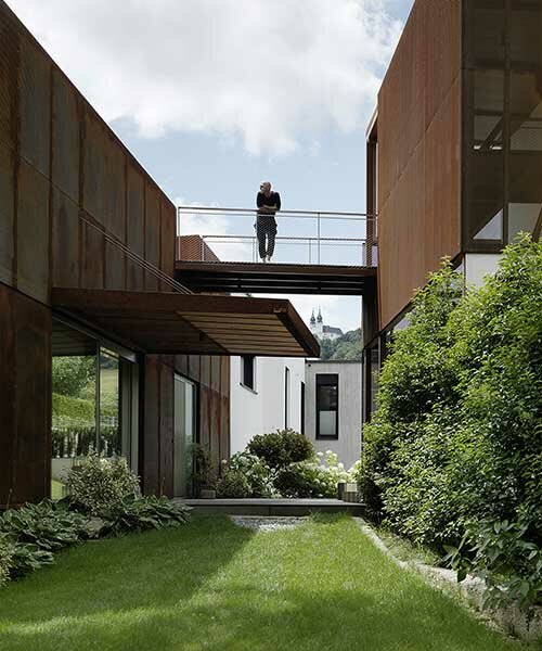 a trio of rusted steel volumes forms this 'deconstructed house' in austria
