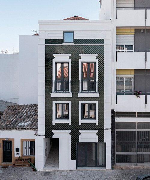 corpo atelier adheres tiled facade and window frame fragments to building in portugal