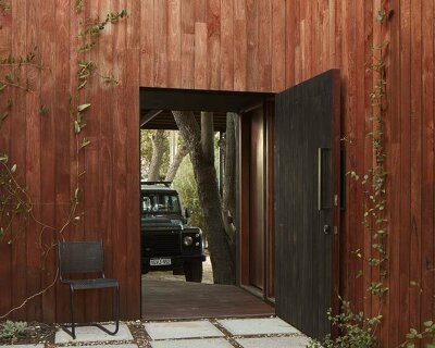 grotto studio extends perth cottage with charred timber 'shadow house'