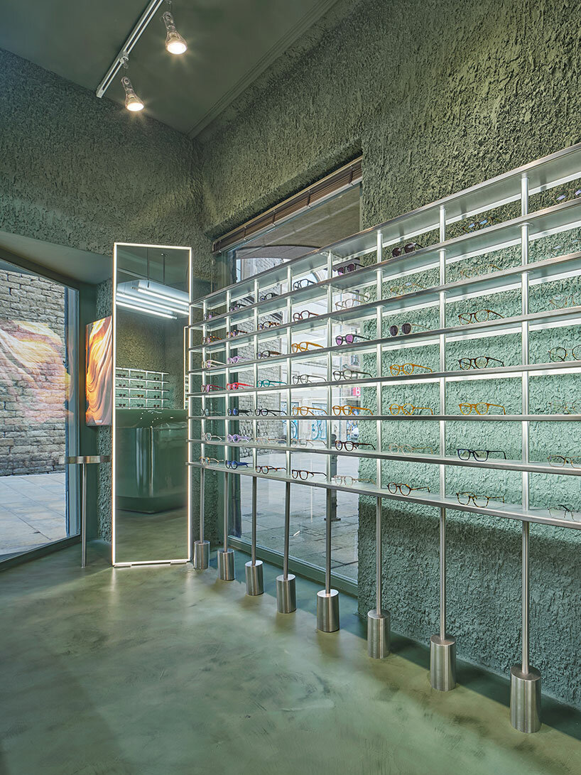 high-tech elements and 'texturized minimalism' shape all-green optical boutique in barcelona