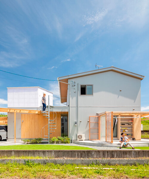 translucent plastic layers and timber frames expand house M in japan