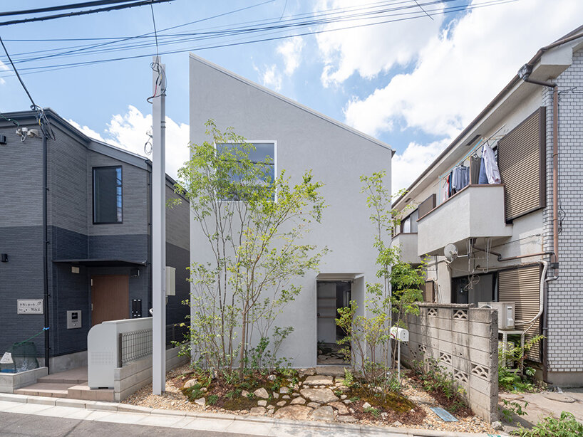 tubular membrane roof casts a soft glow over this two-story house in tokyo