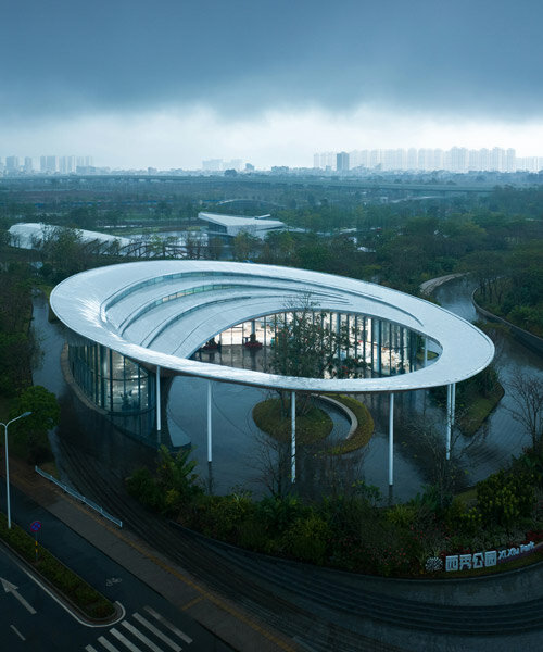 MUDA-architects' coastal haikou visitor center enclosed by a fluid, cascading rooftop