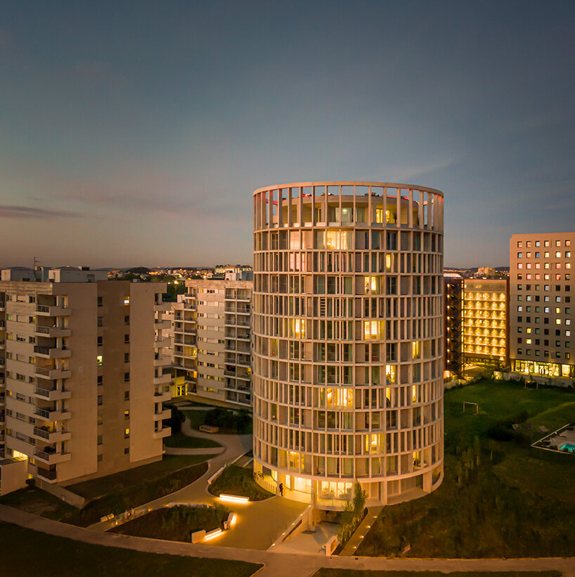 concrete pillars wrap around OODA's cylindrical student housing tower in porto