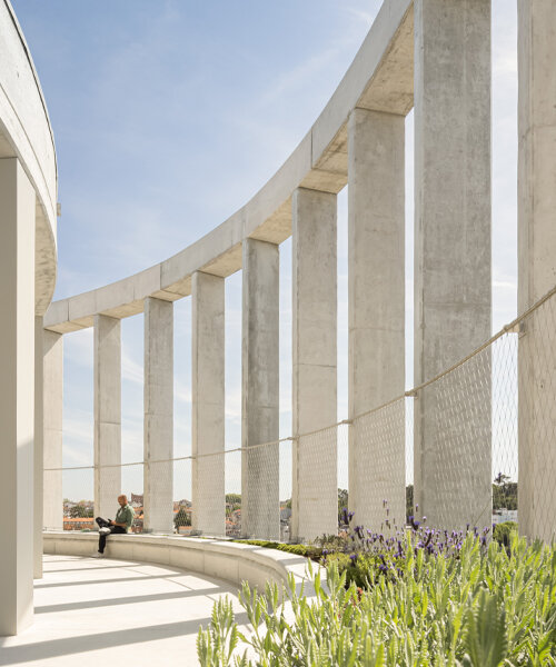concrete pillars wrap around OODA's cylindrical student housing tower in porto