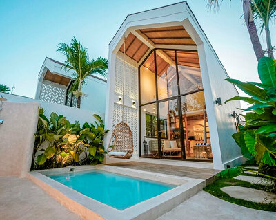 double-height tiny villa in bali develops a flexible layout within a limited build footprint