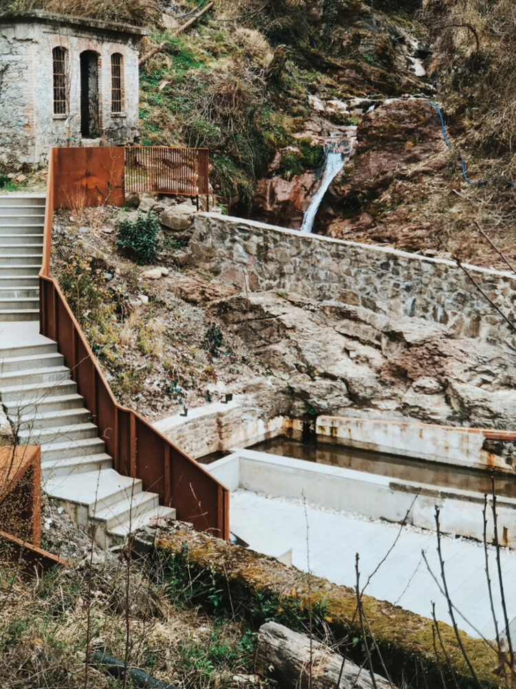 corten steel and stone components revamp collapsed open washhouse in italy