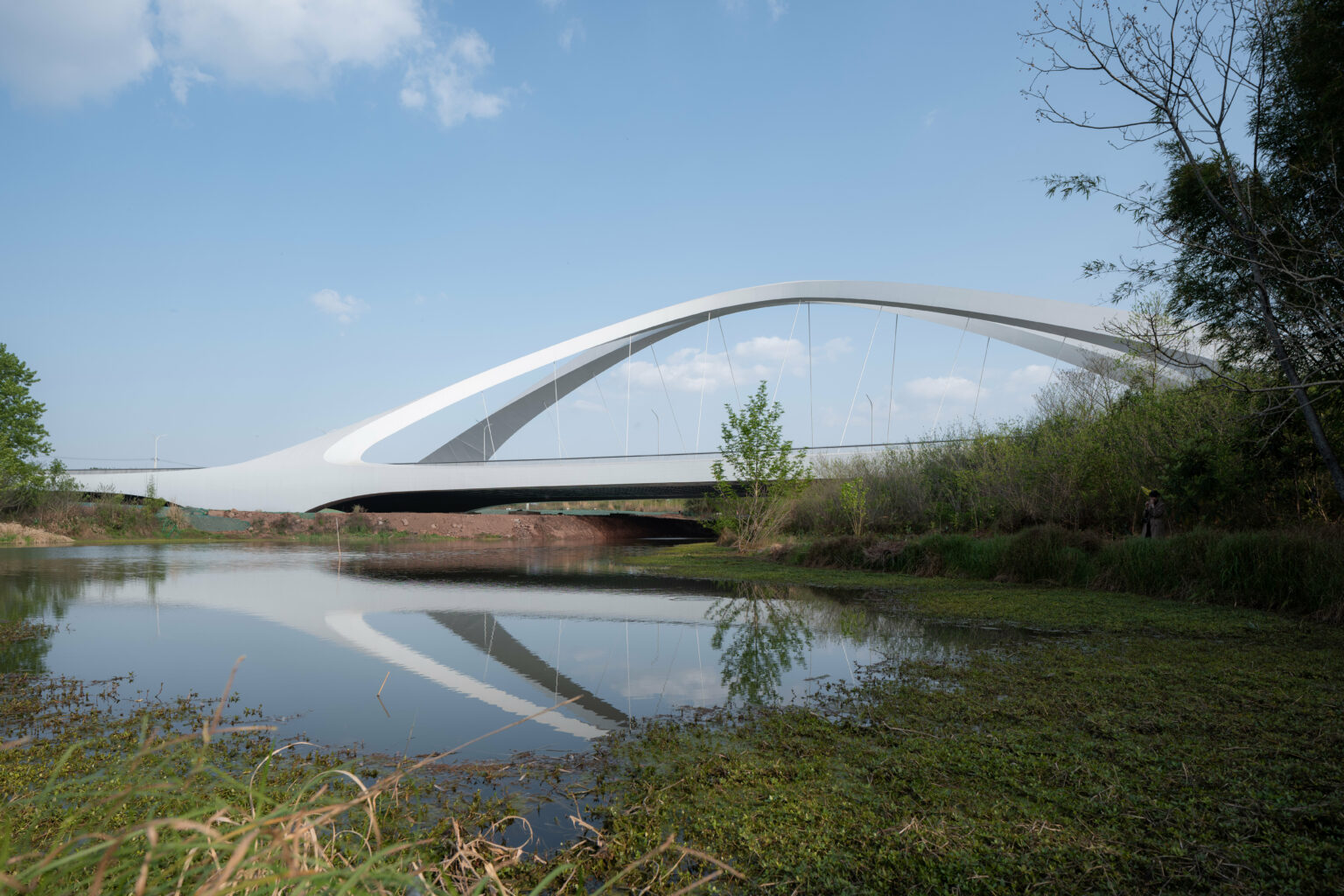 Cimitrical Ridge Building zaha hadid architects sculpts double-arched symmetrical bridge across ...