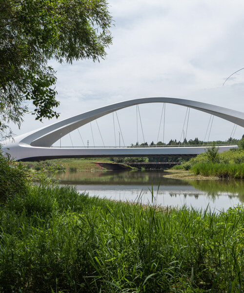 zaha hadid architects sculpts double-arched symmetrical bridge across jiangxi river in china