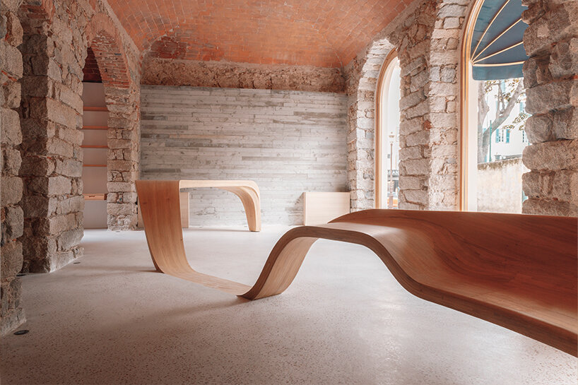 amelia tavella's curvilinear furniture-sculpture hybrid twists from seat to desk 