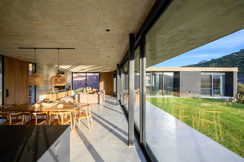arpon arquitectura's L-shaped concrete family retreat in argentina fosters social gatherings