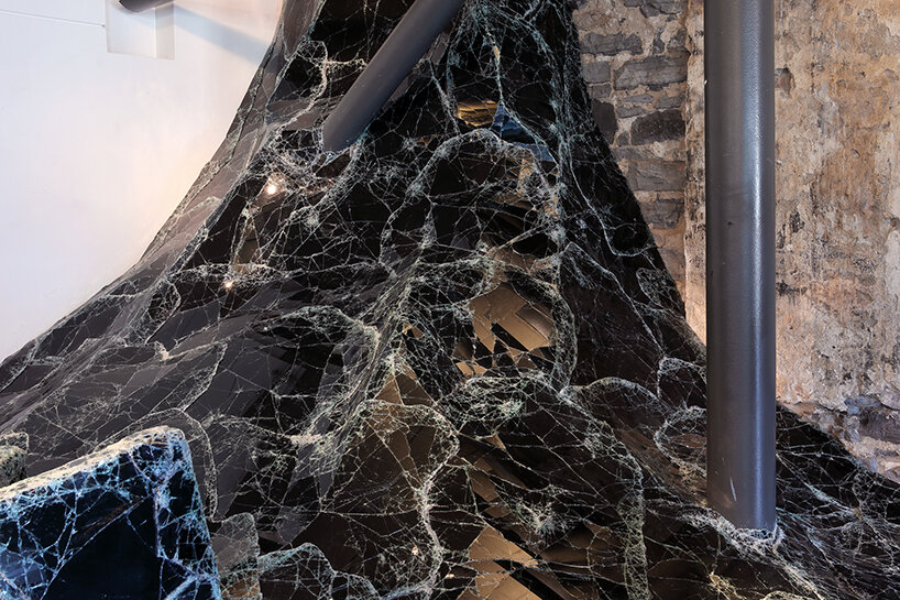 dark tide: baptiste debombourg recreates a magma flow disaster using broken black glass