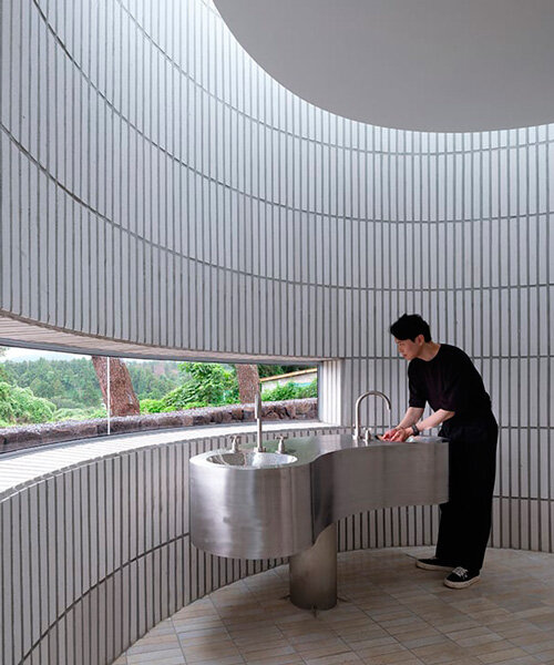 ceramic tiles coat the rounded form of jungmun catholic church unit in south korea