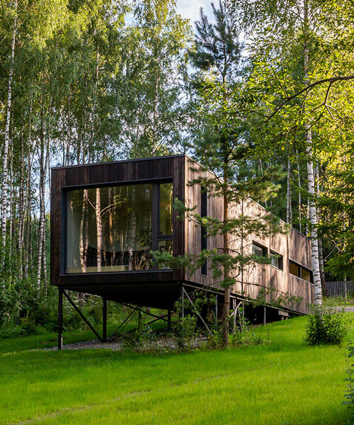 LEVEL 80 architects' prefabricated modular house perches on stilts, preserving its natural terrain