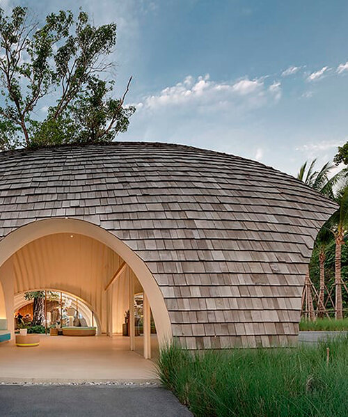 onion designs hotel's dome-shaped lobby clad in wooden shingles in thailand