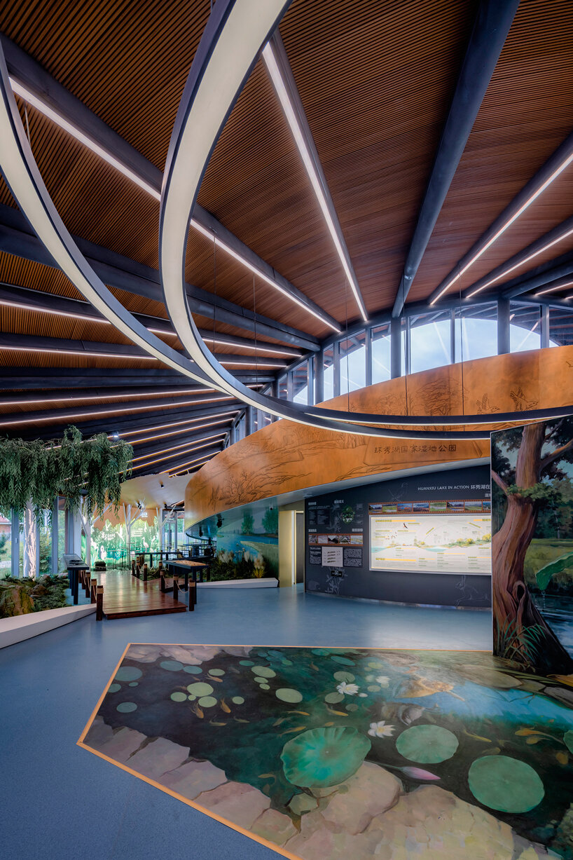 sculptural roof informs the ring-shaped design of lake education center in china