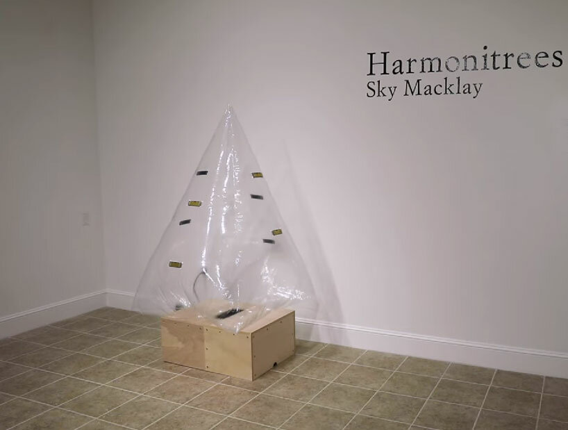 inflatable tree-shaped sculpture by sky macklay plays the harmonica when you hug it