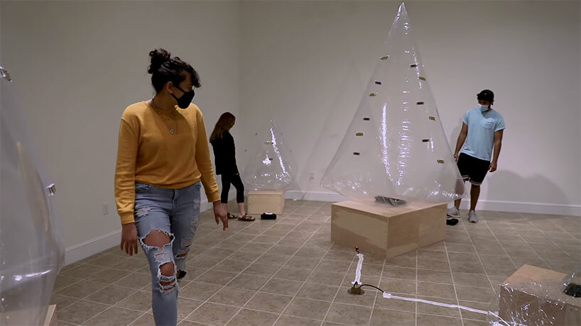 inflatable tree-shaped sculpture by sky macklay plays the harmonica when you hug it