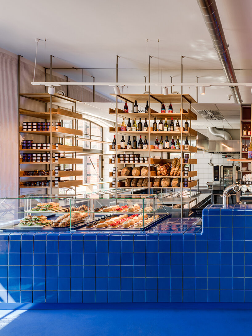cobalt blue and warm orange tones pair up inside poland's pastry club woda