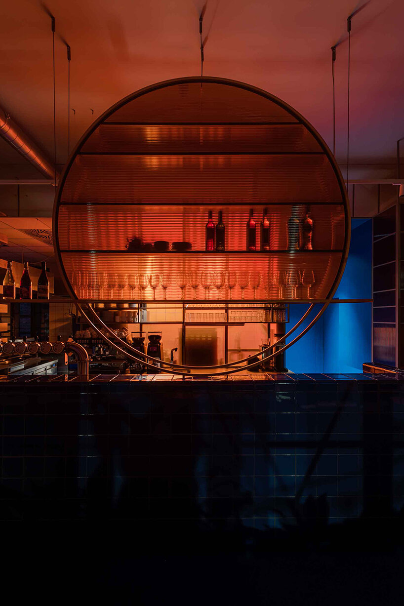 cobalt blue and warm orange tones pair up inside poland's pastry club woda