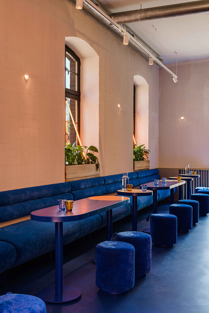cobalt blue and warm orange tones pair up inside poland's pastry club woda