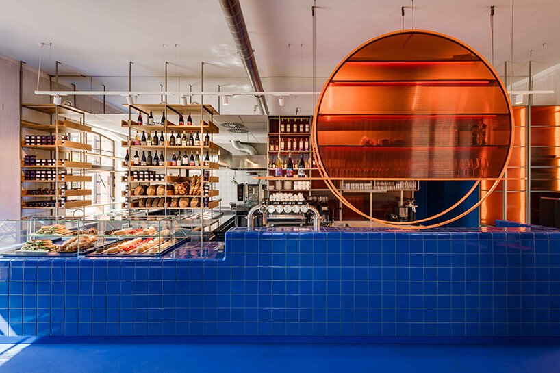 cobalt blue and warm orange tones pair up inside poland's pastry club woda