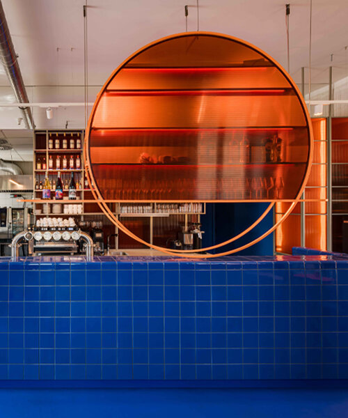 cobalt blue and warm orange tones pair up inside poland's pastry club woda