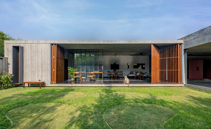 workspace in india showcases a material palette of wood, concrete, and kota stones