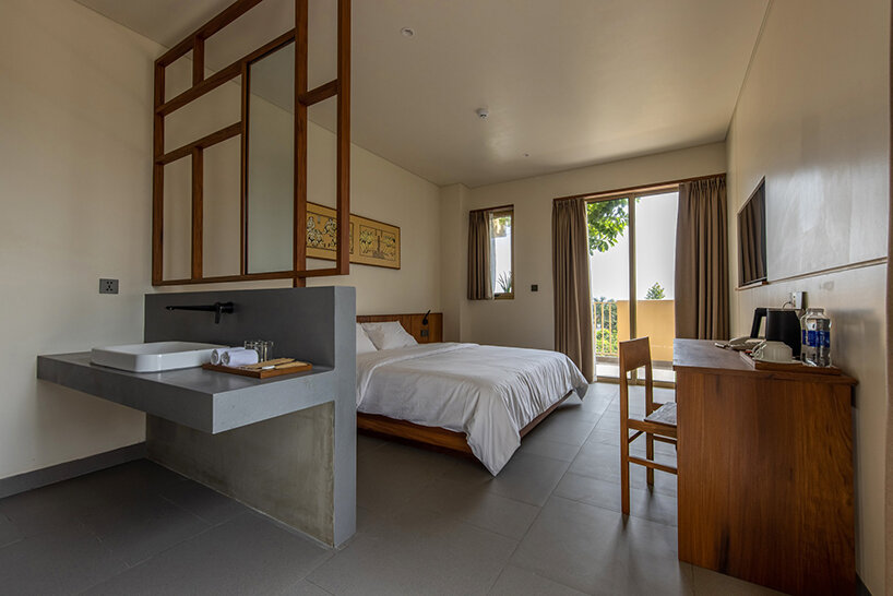 TAA design shapes living complex in vietnam as a matrix of flying blocks & large trees