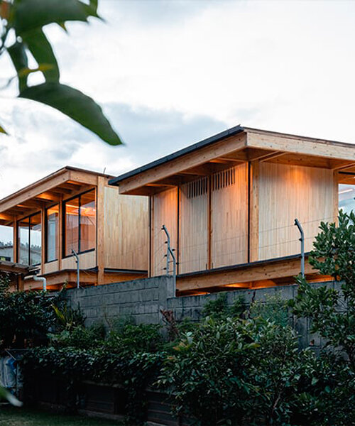 two identical wooden blocks form a mirroring c-shape residence in ecuador