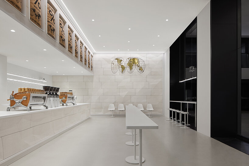 % arabica's flagship in toronto reveals faceted walls inspired by glacial and rock formations