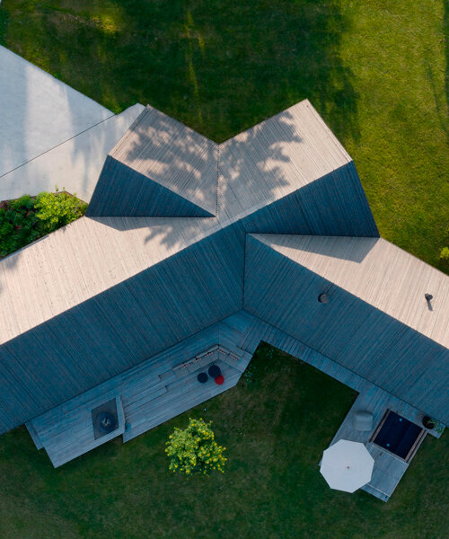 two intersecting saddle roofs shield DMAA's house f in slovenia