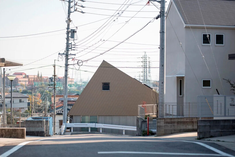 waved steel sheets enfold industrial-styled residence by slow architects