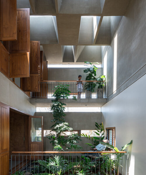 streams of natural light pour down on A threshold's green-terraced residence in bangalore