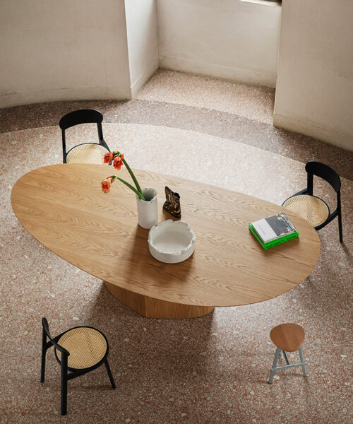 curving tabletops perch atop a monolithic, leaf-shaped base for miniforms' monoplauto table