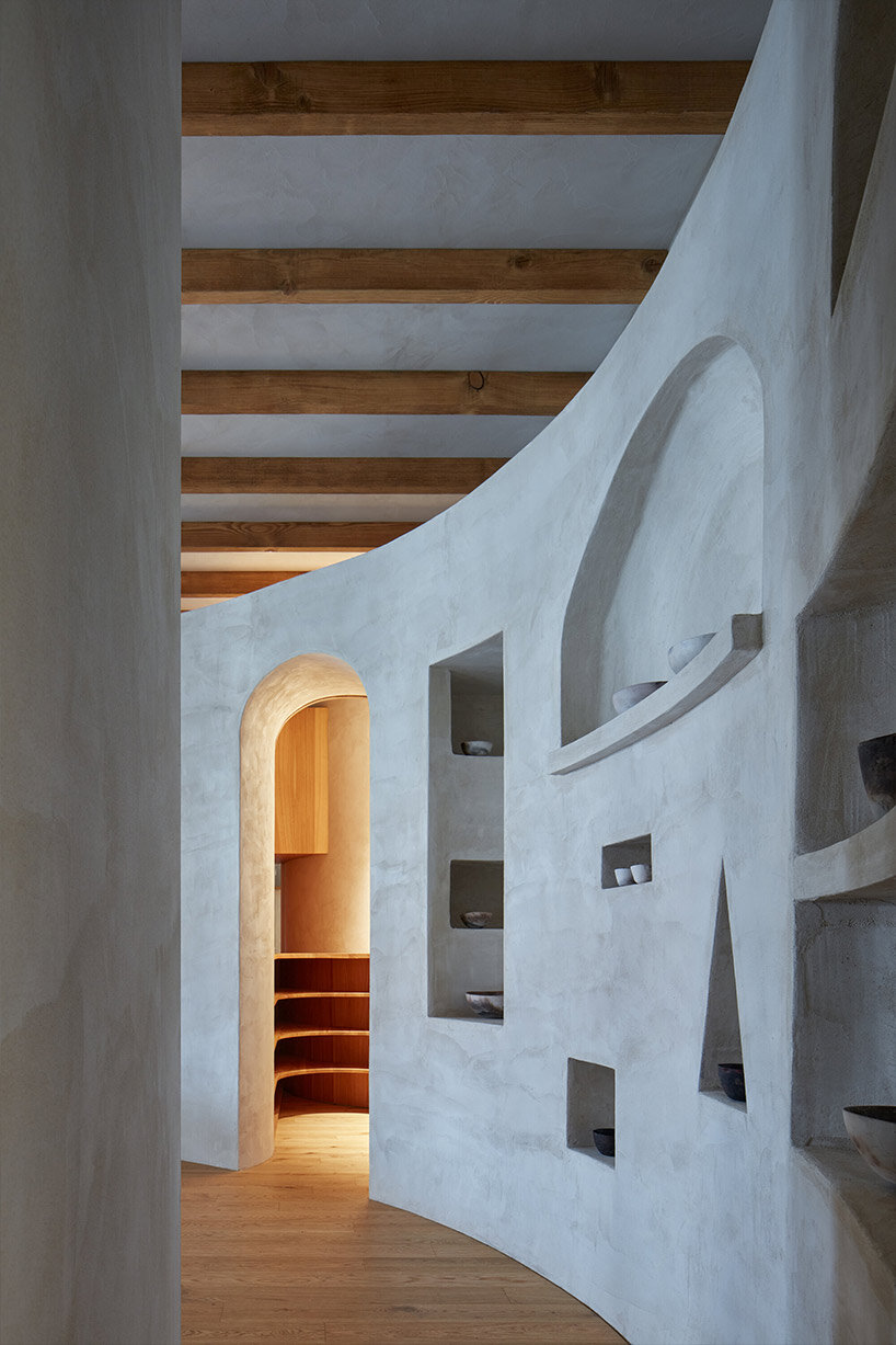 open-plan apartment in prague integrates hidden niches, arches & intricate patterns