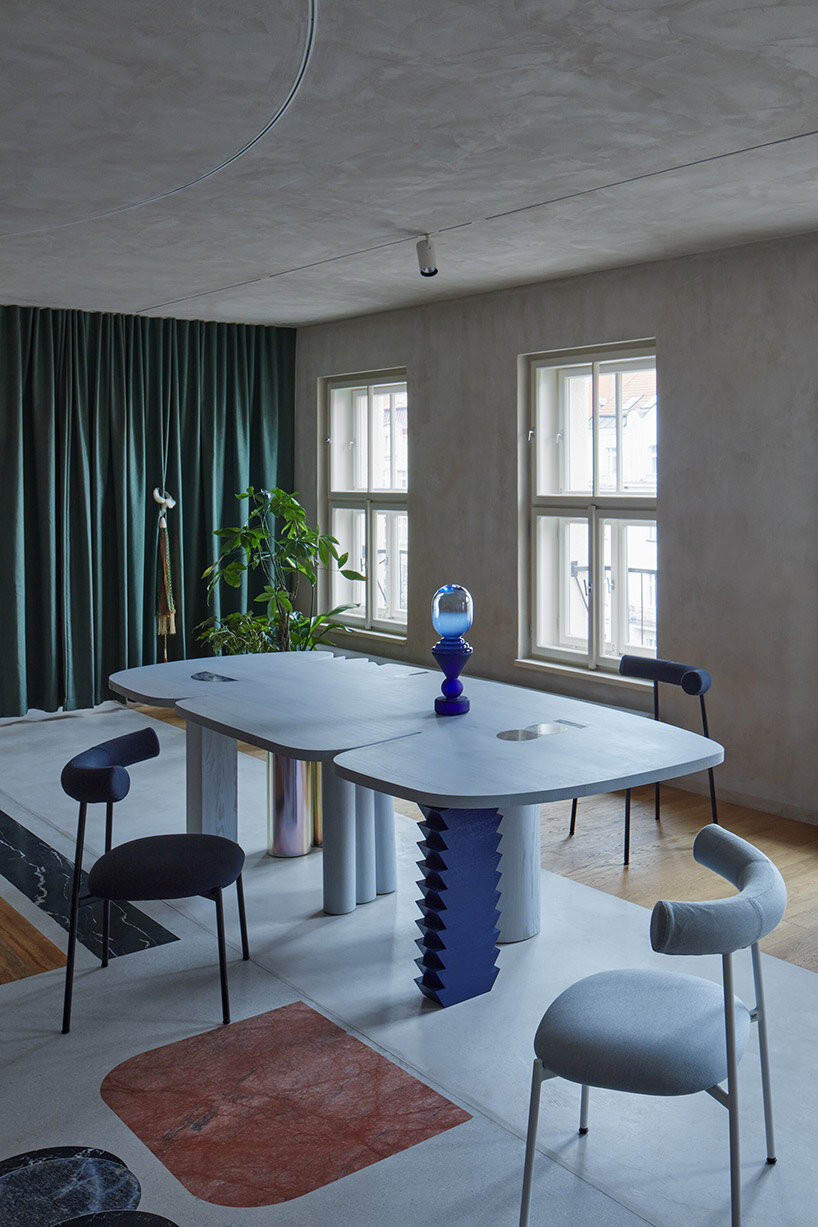open-plan apartment in prague integrates hidden niches, arches & intricate patterns